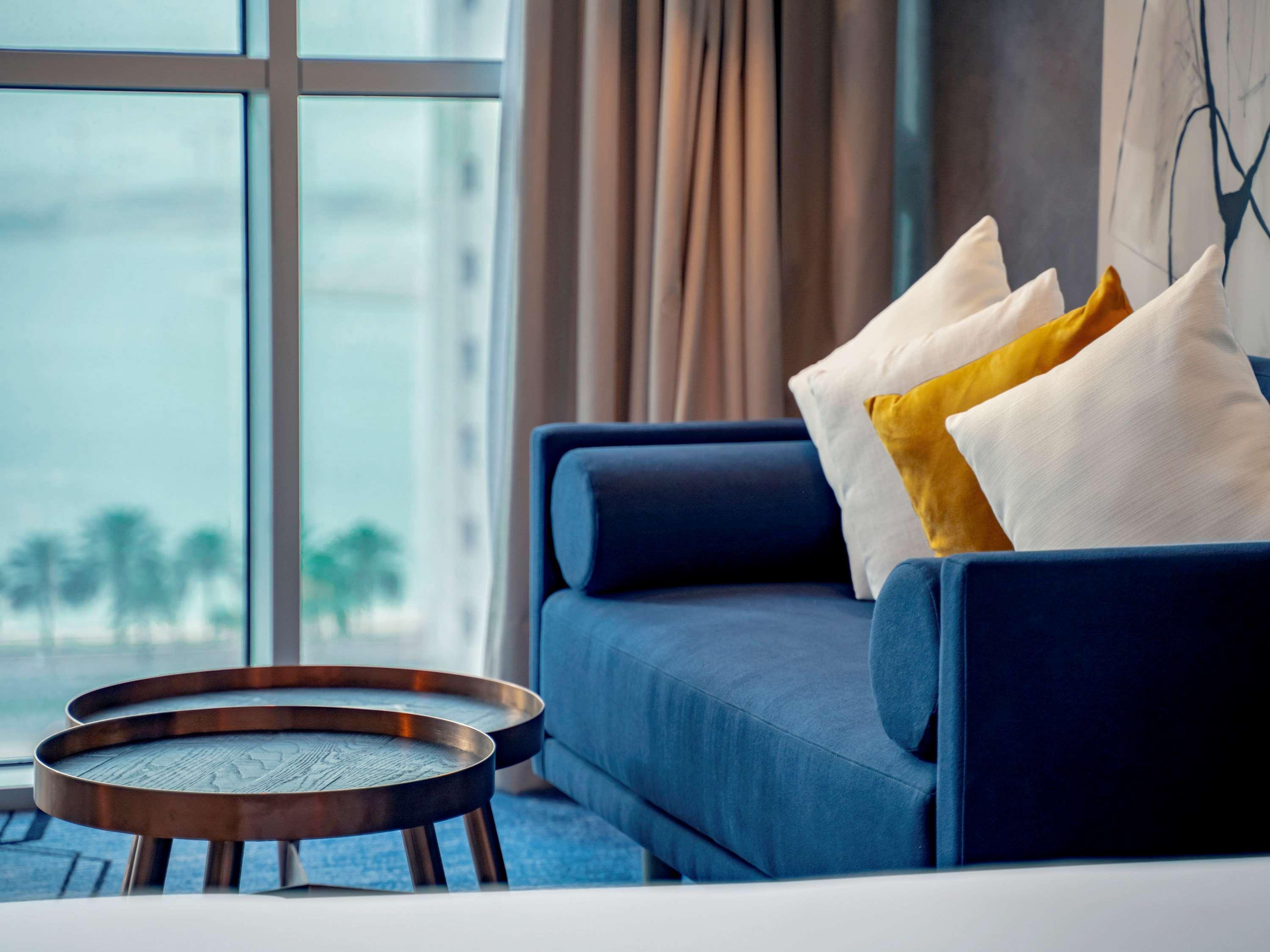 Pullman Sharjah Hotel Екстериор снимка A sofa in a hotel room